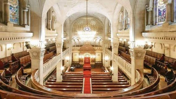 Ornate interior of Templo Libertad, Buenos Aires, showing wooden pews, balconies and stained glass windows – Buenos Aires Jewish City Tour