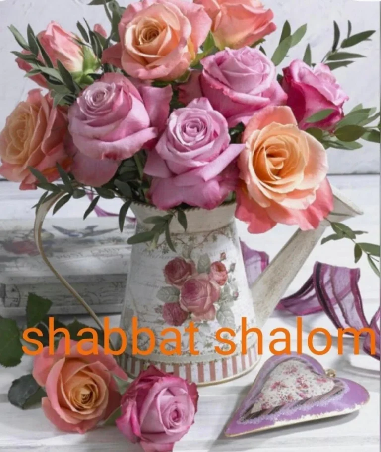 A beautiful arrangement of pink, peach, and coral roses in a vintage floral watering can, surrounded by delicate greenery, decorative hearts, and rustic white wooden details, with the words “Shabbat Shalom” in orange lettering. A charming floral greeting celebrating peace, love, and blessings for the Jewish Sabbath.