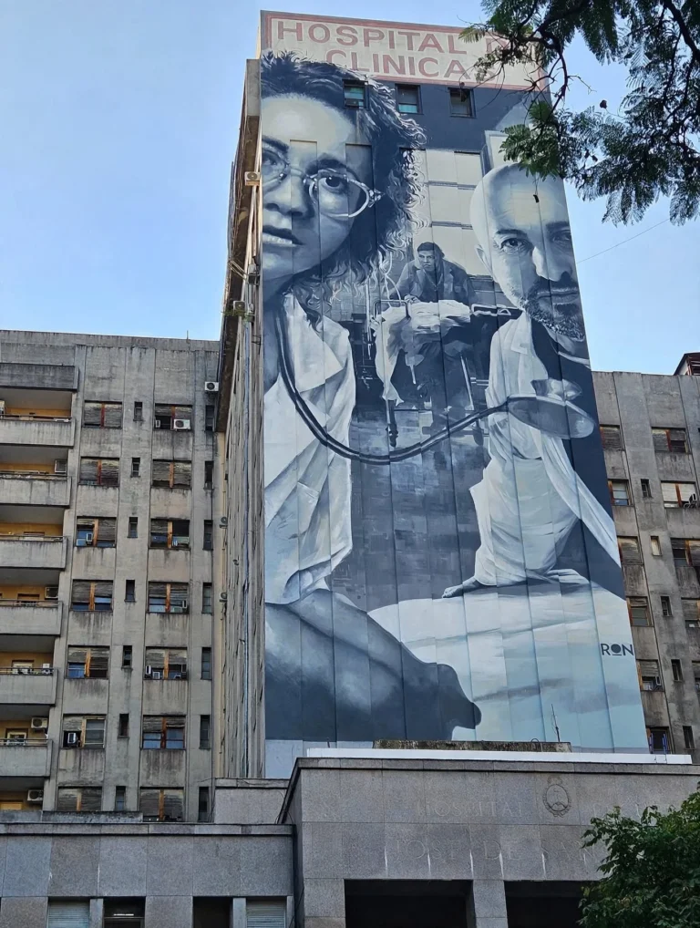 Monumental mural by Martin Ron on Hospital de Clinicas Jose de San Martin facade in Buenos Aires honoring doctors who treated victims